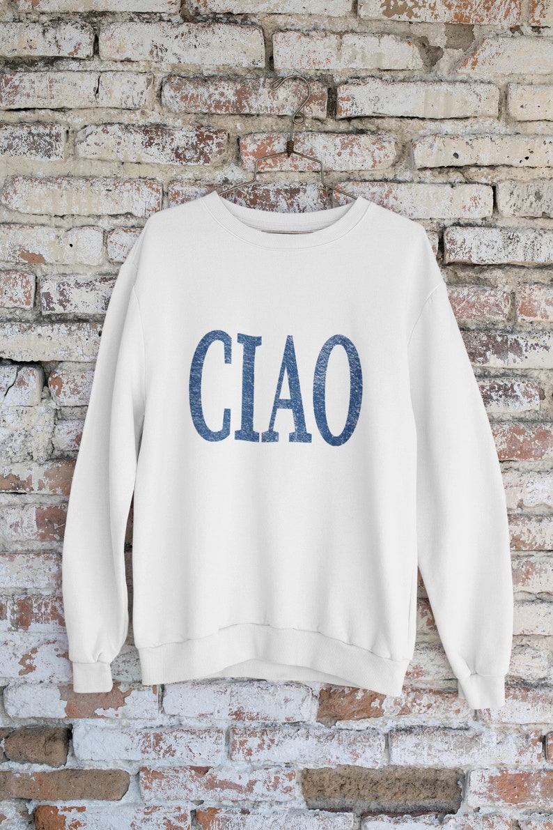 May include: White sweatshirt with a blue "CIAO" graphic printed on the front.