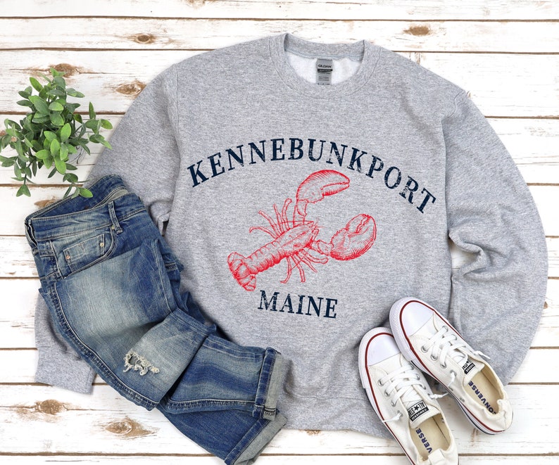May include: Gray sweatshirt with a red lobster graphic and the text "Kennebunkport Maine".