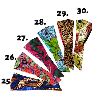 Pode incluir: Um conjunto de 6 faixas de cabe&ccedil;a coloridas com diferentes padr&otilde;es de impress&atilde;o africana. As faixas de cabe&ccedil;a est&atilde;o dispostas em forma de leque, com os n&uacute;meros de 25 a 30 impressos no fundo branco.