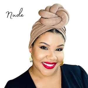 Peut inclure: Un turban de couleur nude avec un nœud sur le dessus. Le turban est fait d'un tissu doux et texturé.