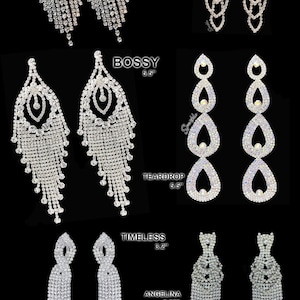 May include: Ten pairs of crystal rhinestone dangle earrings in various styles. The earrings are named "Cute", "Spunky", "Bossy", "Teardrop", "Timeless", and "Angelina". Each style is available in two sizes, ranging from 2.25 inches to 5.5 inches.