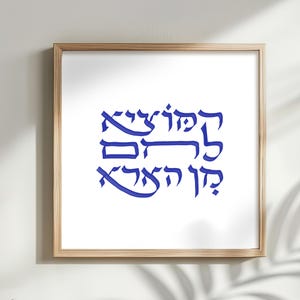 May include: A white ceramic mug with a black handle and the text "But First, Coffee" in a bold, black font. The mug is set against a blurred background, suggesting a cozy setting.