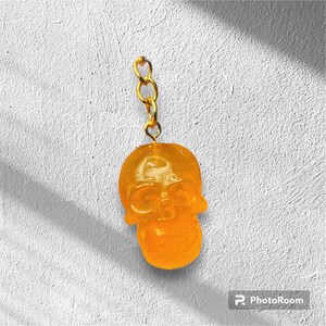 Small sized orange  resin skull keychain with glitter and pink foil