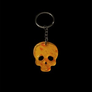 Small sized orange  resin skull keychain with glitter and pink foil