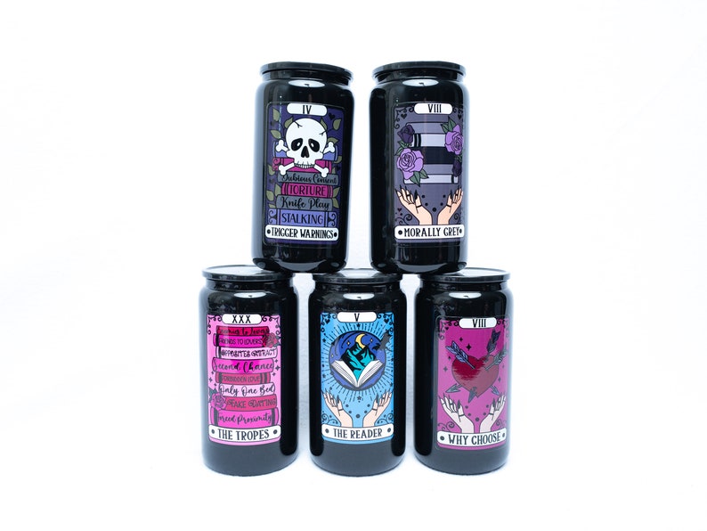 May include: Six black jars with colorful tarot card designs. The jars feature the following text: IV, VIII, XXX, V, VIII, and VIII. The text on the jars reads: "Subtle Cues", "Torture", "Knife Play", "Stalking", "Trigger Warnings", "Morally Grey", "No More Secrets", "Haunted", "Second Chances", "Friendly Fire", "Once You've Had", "Space Granted", "The Tropes", "The Reader", "Why Choose".