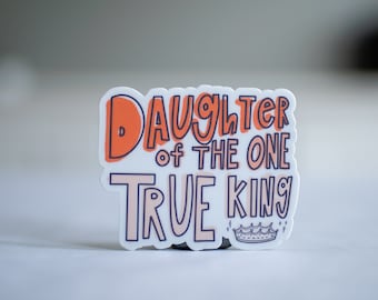 May include: White sticker with the text "Daughter of the One True King" in pink and orange lettering with a crown and stars.