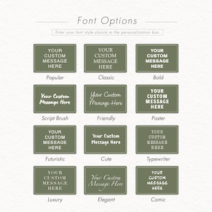 May include: An image showcasing font options for personalization. The text "Font Options" is at the top, with the prompt "Enter your font style choice in the personalization box." Below are 12 examples, each with a text box displaying "YOUR CUSTOM MESSAGE HERE" in different fonts.