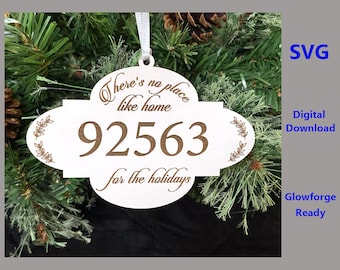 May include: White wooden Christmas ornament with a brown inscription that reads "There's no place like home 92563 for the holidays".