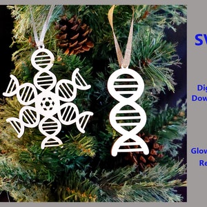 May include: Two white, laser-cut, Christmas ornaments shaped like a snowflake and a double helix. The snowflake is made up of six DNA strands. The ornaments are hanging from a Christmas tree.