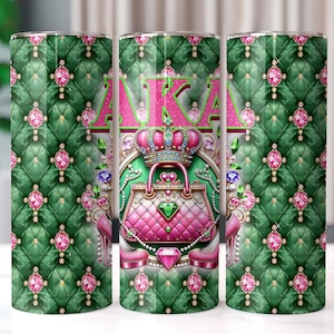 May include: A green and pink tumbler with a quilted pattern and a pink purse with a crown on top. The tumbler has the letters AKA in pink on the front.