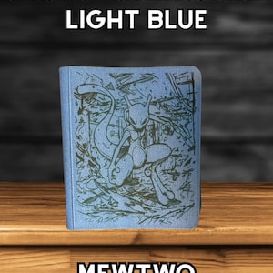 May include: Light blue 9-page top loader TCG binder featuring a Mewtwo graphic. The binder has the text "9 PAGE TOP LOADER TCG BINDER LIGHT BLUE" at the top and "MEWTWO" at the bottom.