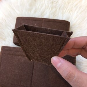 May include: Brown felt organiser insert with multiple compartments for a handbag or purse.