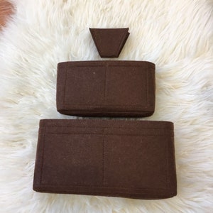 May include: A set of three brown felt bag organisers. The largest organiser has three compartments, the medium organiser has two compartments, and the smallest organiser is a triangular shape.