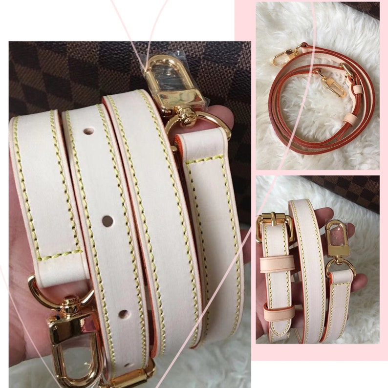 May include: A white leather strap with gold hardware and orange stitching. The strap is folded in half and has a gold clasp.