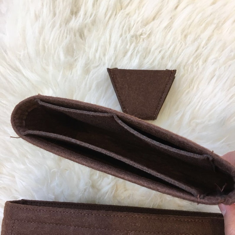 May include: Brown felt bag organiser with multiple compartments and a separate triangular felt piece.