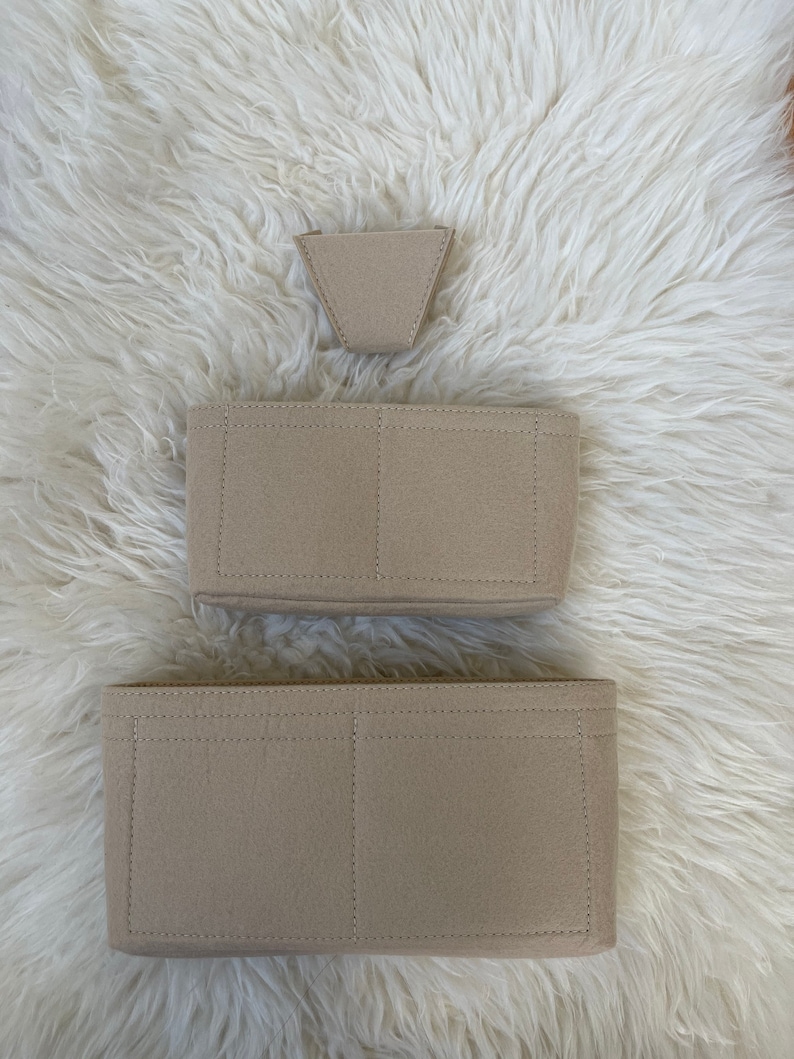 May include: Three beige felt bag organisers with different compartments. The top organiser is a small triangle shape, the middle organiser has two compartments, and the bottom organiser has three compartments.