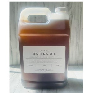 May include: A gallon jug of organic Batana Oil, a herbal infusion rapid growth blend. The label reads "Organic Batana Oil Herbal Infusion Rapid Growth Blend".