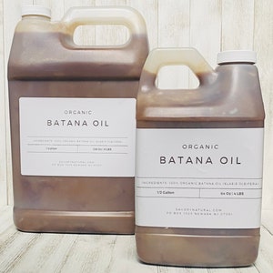 May include: Two brown plastic jugs of organic Batana oil. The larger jug is 1 gallon and the smaller jug is 1/2 gallon. Both jugs have white labels with the product name and ingredients.