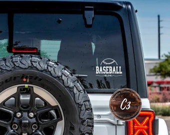May include: White vinyl decal with the text "BASEBALL MOM" and a baseball graphic on a white Jeep. The decal is on the back window of the vehicle.