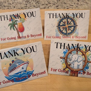 May include: Four thank you cards with travel-themed illustrations. Each card has the words "THANK YOU" in large black letters. The cards feature a cocktail, compass, cruise ship, and an elephant with a ship's wheel. The phrase "For Going Above & Beyond" is also printed on each card.