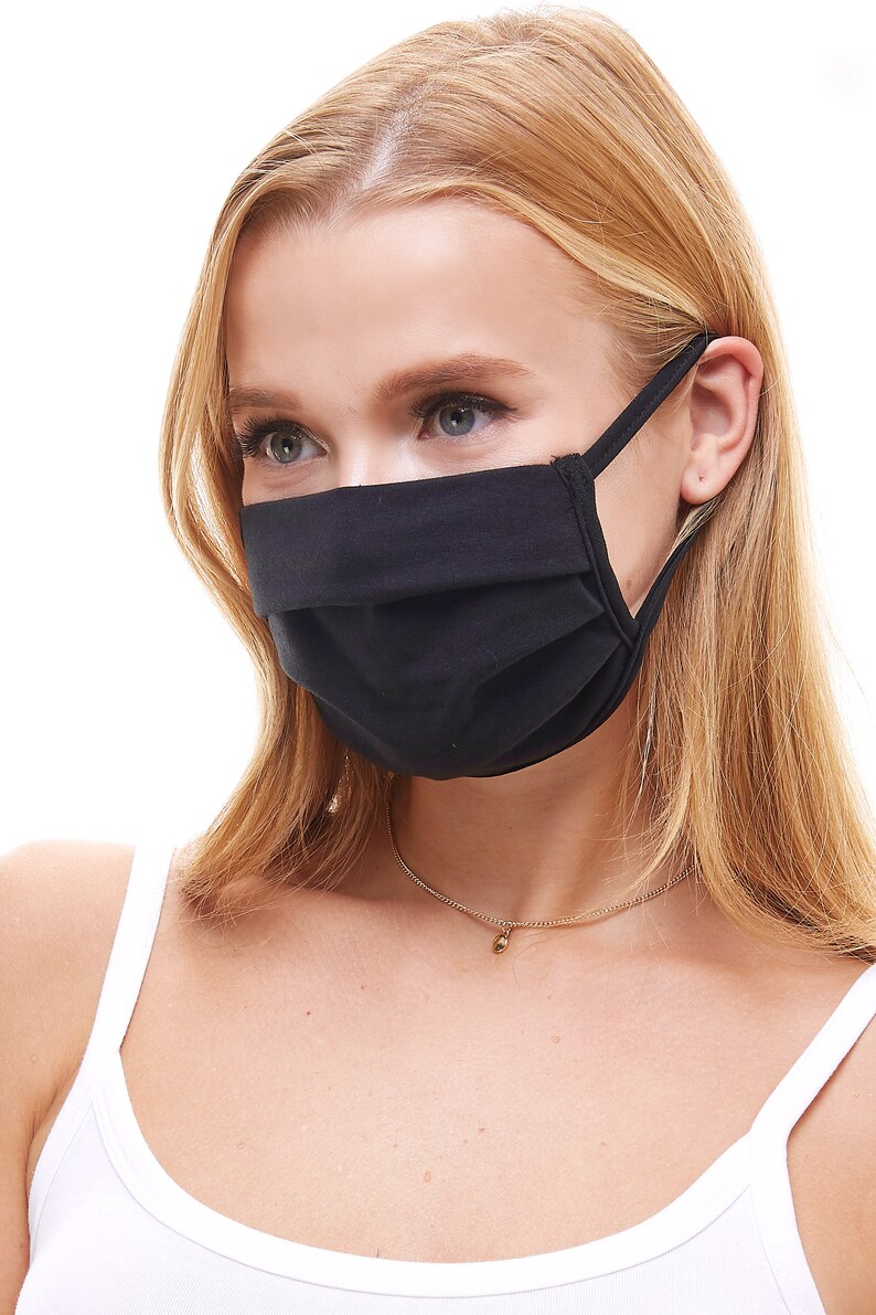 May include: A person wearing a black face mask with a white tank top and a gold necklace.