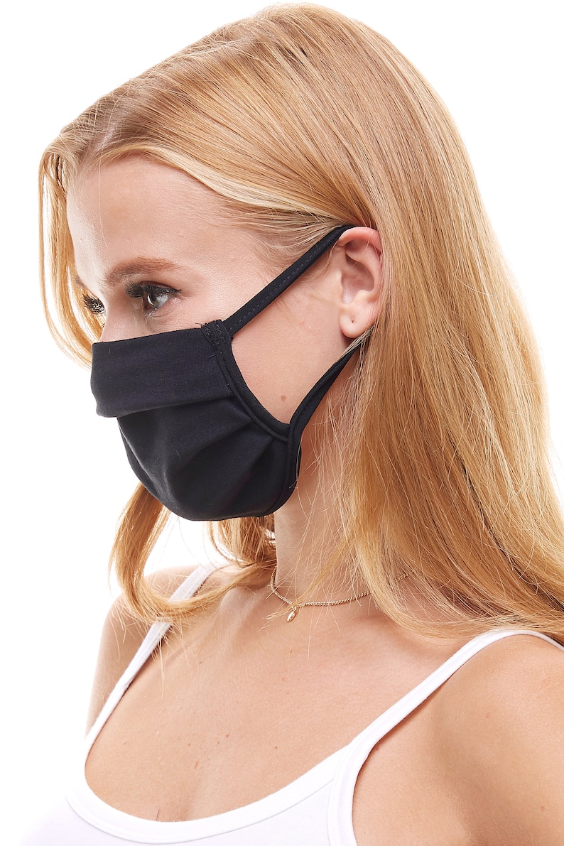 May include: A black face mask with adjustable ear loops. The mask is made of a soft, breathable fabric and is designed to provide a comfortable fit.