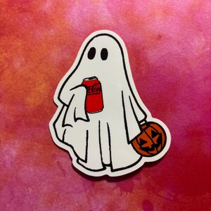 May include: A white ghost sticker with black eyes and outline, holding a red Coca-Cola can and a carved orange pumpkin. The sticker is on a pink and red background, perfect for Halloween.