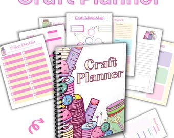 May include: A pink and white craft planner with a spiral binding. The cover features a colorful illustration of sewing supplies, including spools of thread, buttons, scissors, and a ruler. The text "Craft Planner" is printed in pink letters on the cover. The planner has 60 pages.