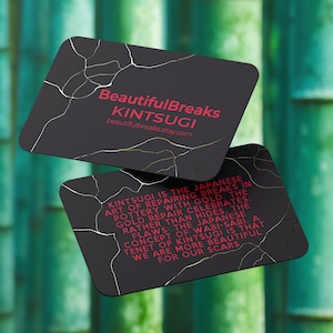 May include: Two black business cards with gold and white crackle patterns. The top card reads "Beautiful Breaks Kintsugi" and "beautifulbreaks.etsy.com". The bottom card has a quote about Kintsugi, the Japanese art of repairing pottery with gold.