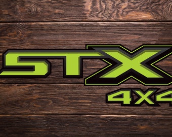 May include: Green and black "STX 4x4" logo on a brown wood background.