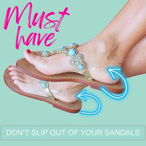 May include: Brown leather sandals with gold straps and turquoise and crystal embellishments. The sandals have a clear strap to secure the foot. The text "Must have" and "Don't slip out of your sandals" are visible.