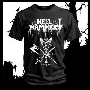 Op de afbeelding: Zwart T-shirt met een witte print. Het ontwerp bevat de bandnaam "HELL HAMMER" in een druipend lettertype, een symbool met bijlen en de tekst "Satanic Rites". Het T-shirt heeft een ronde hals en korte mouwen.