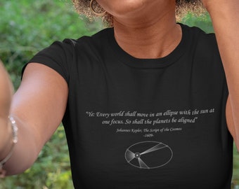 May include: A black t-shirt with a white graphic of an ellipse with the sun at one focus. The text reads "Ye: Every world shall move in an ellipse with the sun at one focus. So shall the planets be aligned" Johannes Kepler, The Script of the Cosmos -1609.