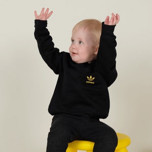 Premium Gold Metallic Stone Roses Inspired Adored Slogan Motif Fan Art Unisex Baby/Toddler Fleece Lined Sweatshirt