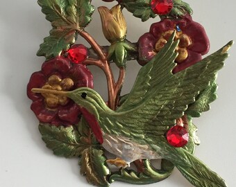 Ruby throated hummingbird on floral stem brooch with Swarovski Crystals. Hand painted in rose, gold and sage colors. Lightweight.