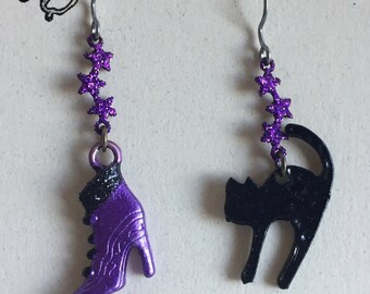 Halloween black cat and fancy witches boot suspended from glittered purple stars. Lightweight. Hypoallergenic t