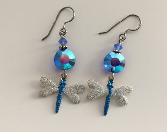 Hand painted Dragonfly earrings with glittery wings and blue body. Hanging from blue glossy bead. Hypoallergenic.