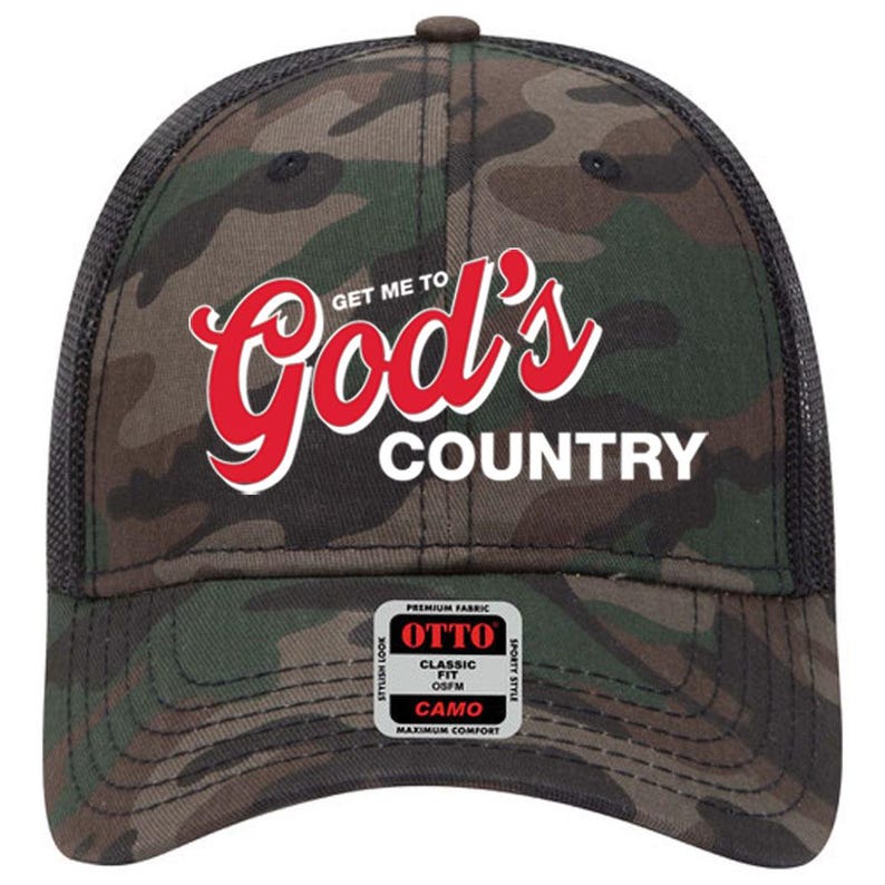 May include: A camouflage baseball cap with the text "GET ME TO God's COUNTRY" in red and white. The cap has a black mesh back and a curved brim. The cap also has a small tag that says "OTTO" and "CAMO".