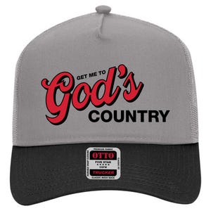 May include: A gray and black trucker hat with the text "Get Me To God's Country" in red and black. The hat has a mesh back and a snap closure. The hat also has a small patch that says "OTTO".