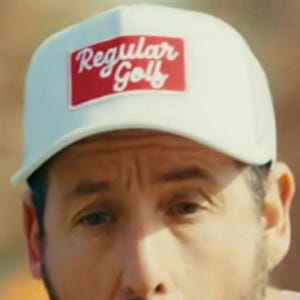 May include: White baseball cap with the text "Regular Golf" in a red rectangle. The hat has a curved brim and a mesh back. The hat is a golf accessory.