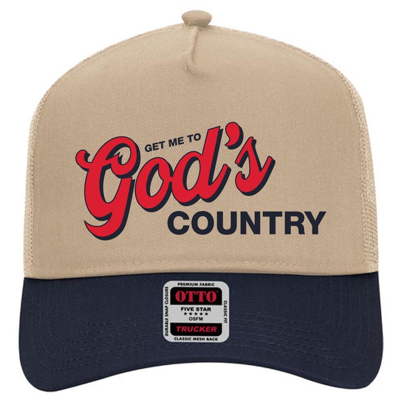 May include: A tan and navy blue trucker hat with the text "GET ME TO God's COUNTRY" in red and black. The hat features a mesh back and a snap closure. The front panel has a patch that says "OTTO".