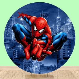 May include: A round backdrop featuring a red and blue superhero character with a spider design. The character is posed in a dynamic action pose against a cityscape background.