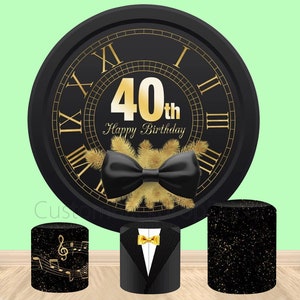 May include: Black and gold 40th birthday party backdrop with a large clock face, a bow tie, and three black and gold cylindrical stands. The clock face has Roman numerals and the text "40th Happy Birthday".