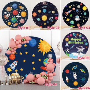 May include: A collection of six round space-themed backdrops. Designs include planets, rockets, astronauts, and the text "Happy Birthday." The backdrops are in various styles, with a dark blue background and colorful illustrations.