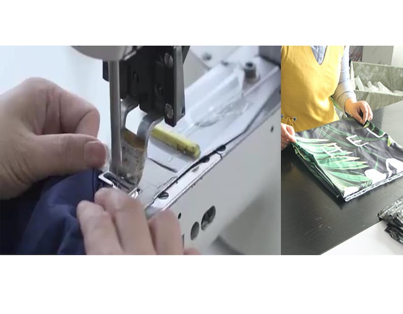 May include: Close-up of a sewing machine needle stitching a dark blue fabric. The fabric is being held in place by a hand. In the background, a person is folding a green and white fabric with a tropical leaf pattern.
