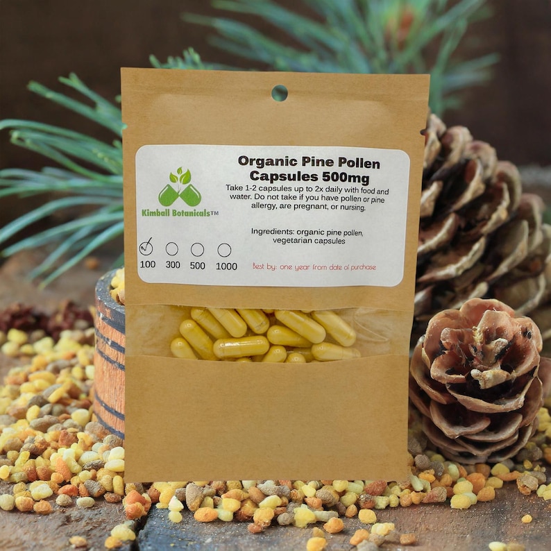 May include: A package of Organic Pine Pollen Capsules 500mg from Kimball Botanicals. The capsules are yellow and visible through a clear window. The label provides usage instructions and ingredient information. The package is in a brown paper bag.