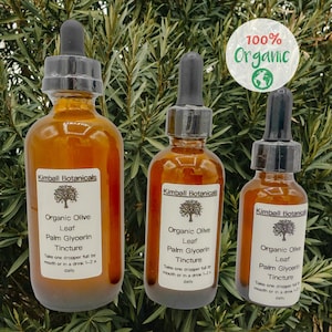 May include: Three amber glass bottles with droppers, labeled "Kimball Botanicals" and containing organic olive leaf palm glycerin tincture. The bottles are arranged in a row from largest to smallest, with the largest bottle in the front. The bottles are sitting on a green leafy background. The label on the largest bottle reads "Take one dropper full by mouth or in a drink 1-2x daily". The label on the middle bottle reads "Take one dropper full by mouth or in a drink 1-2x daily". The label on the smallest bottle reads "Take one dropper full by mouth or in a drink 1-2x daily". The bottles are 100% organic.