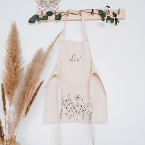 geöffnete hängende Schürze aus Bio Baumwolle in Naturfarbe mit Wildblumen und Pusteblumen-Motiv