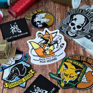 Metal Gear - Embroidered Patch - FOX Hound - DIAMOND Dogs - MSF - Outer Heaven - To Let The World Be - Videogame Emblem - Premium Embroidery