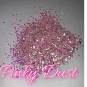 May include: Pinky Dust iridescent glitter in a variety of sizes. The glitter is a light pink colour with a rainbow sheen.